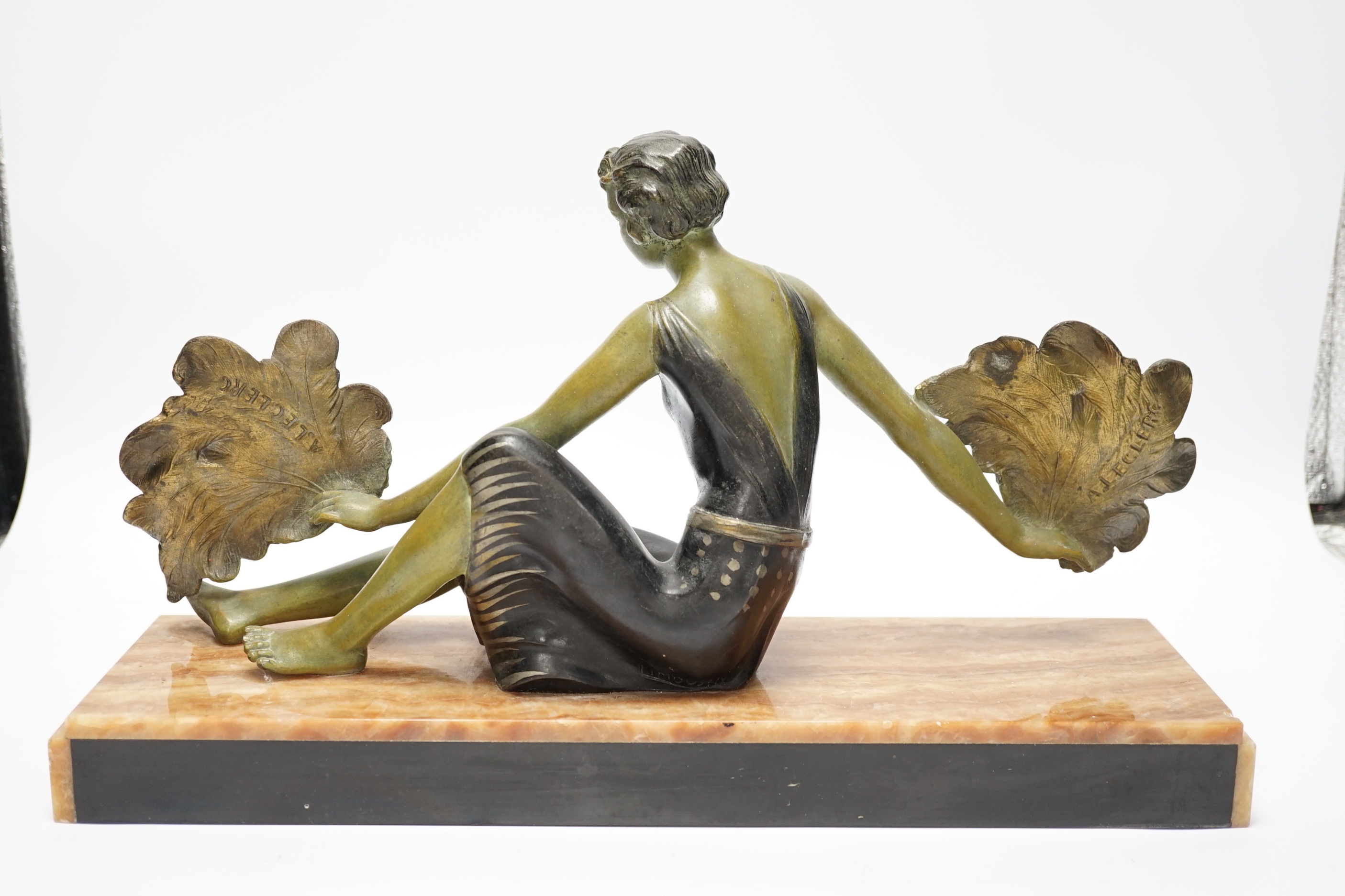 An Art Deco patinated spelter and marble figure, signed A. Leclerc, 40cm wide